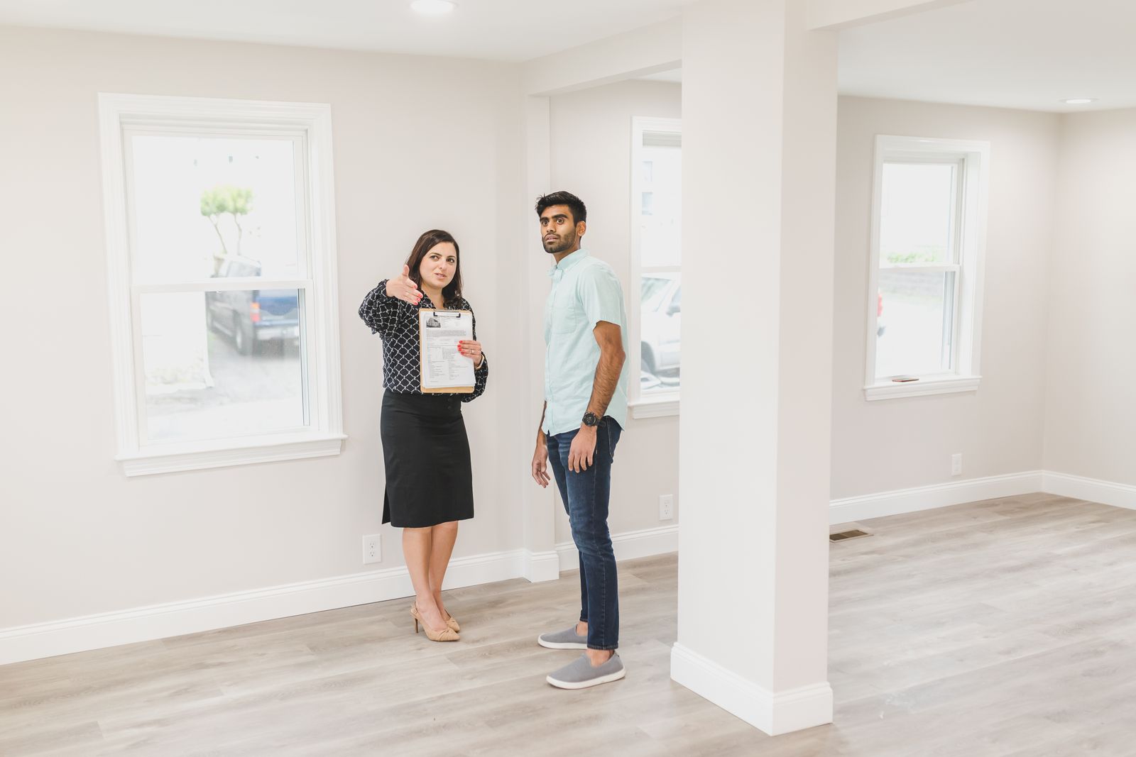 Real estate agent showing a home interior to a buyer